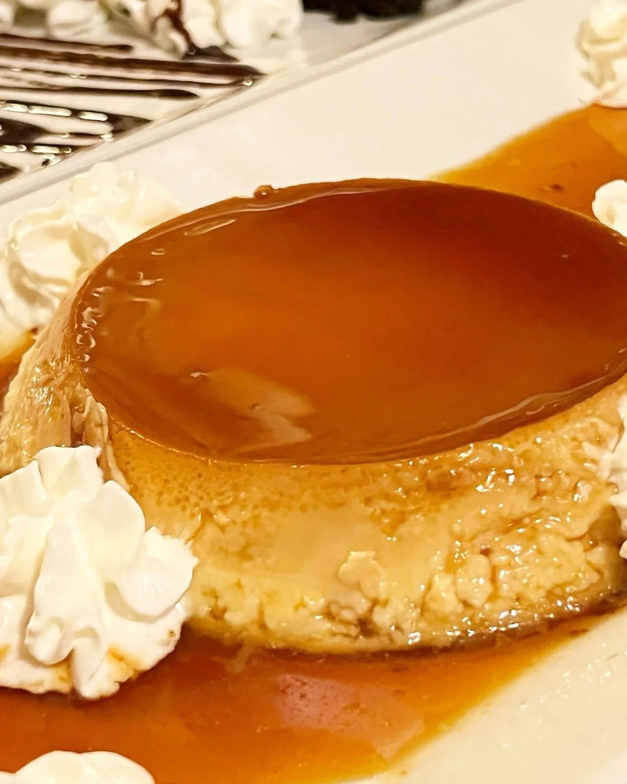 Homemade flan under caramel with whipped cream