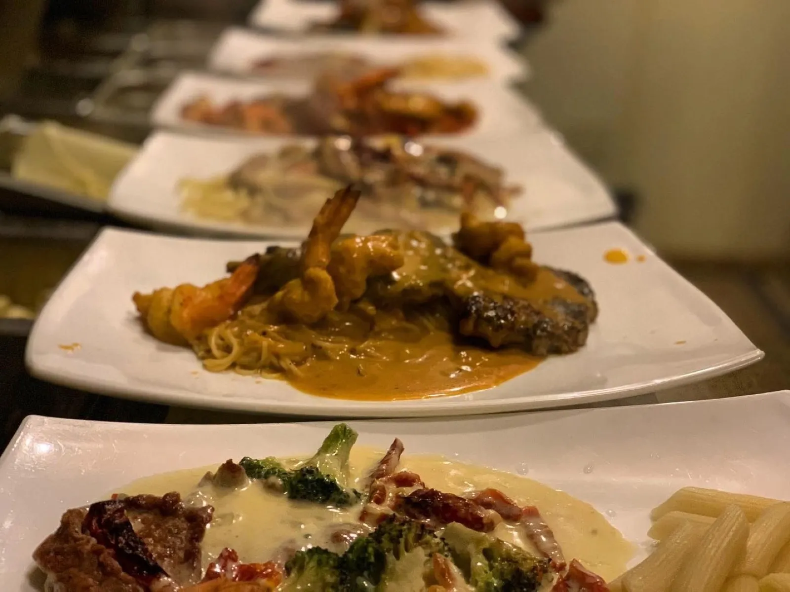 Finished plates lined up on the pass during dinner service